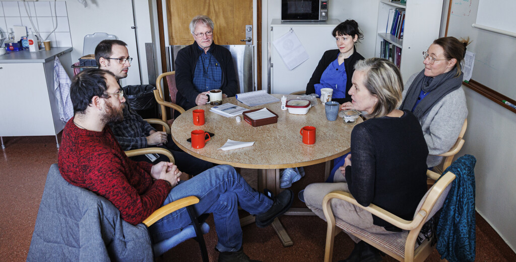 Personer fikar vid ett runt bord